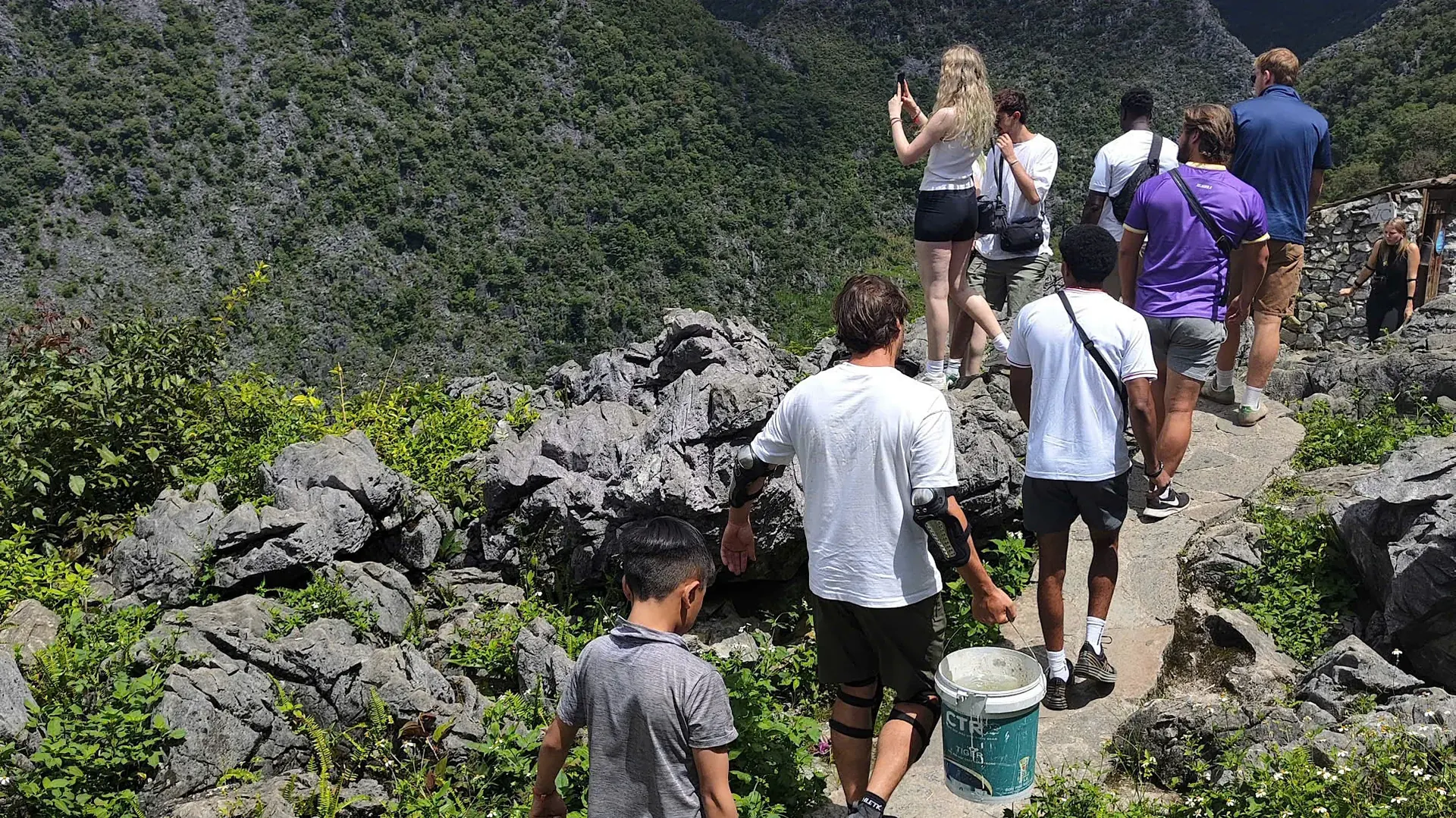 Guests hiking between limestone karst peaks on the Loop