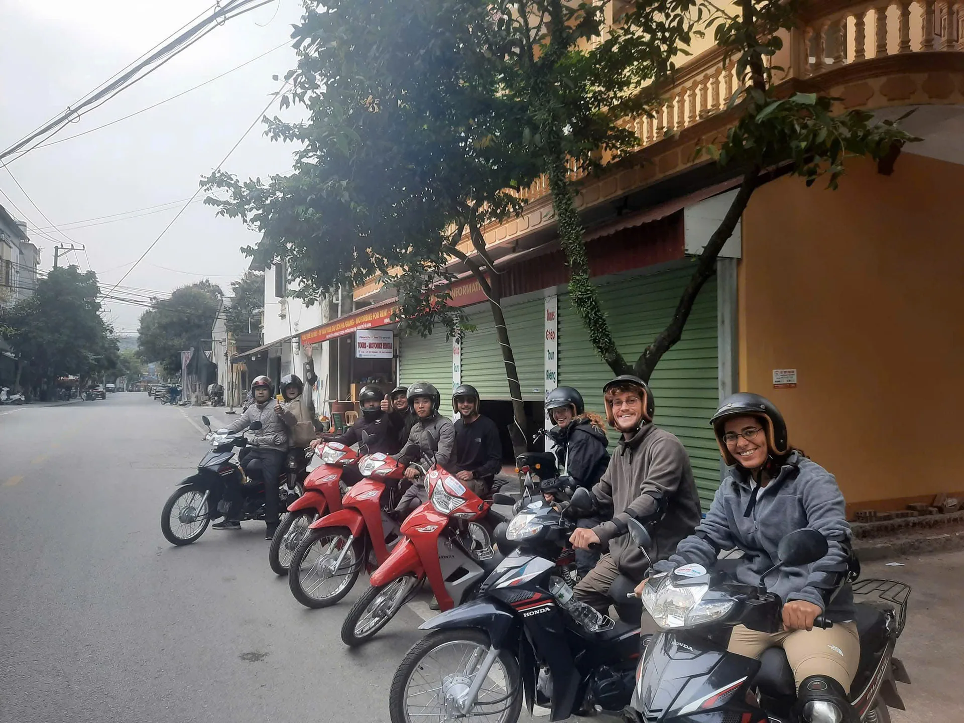 Freedom riders in helmets and gear rolling out of Ha Giang city