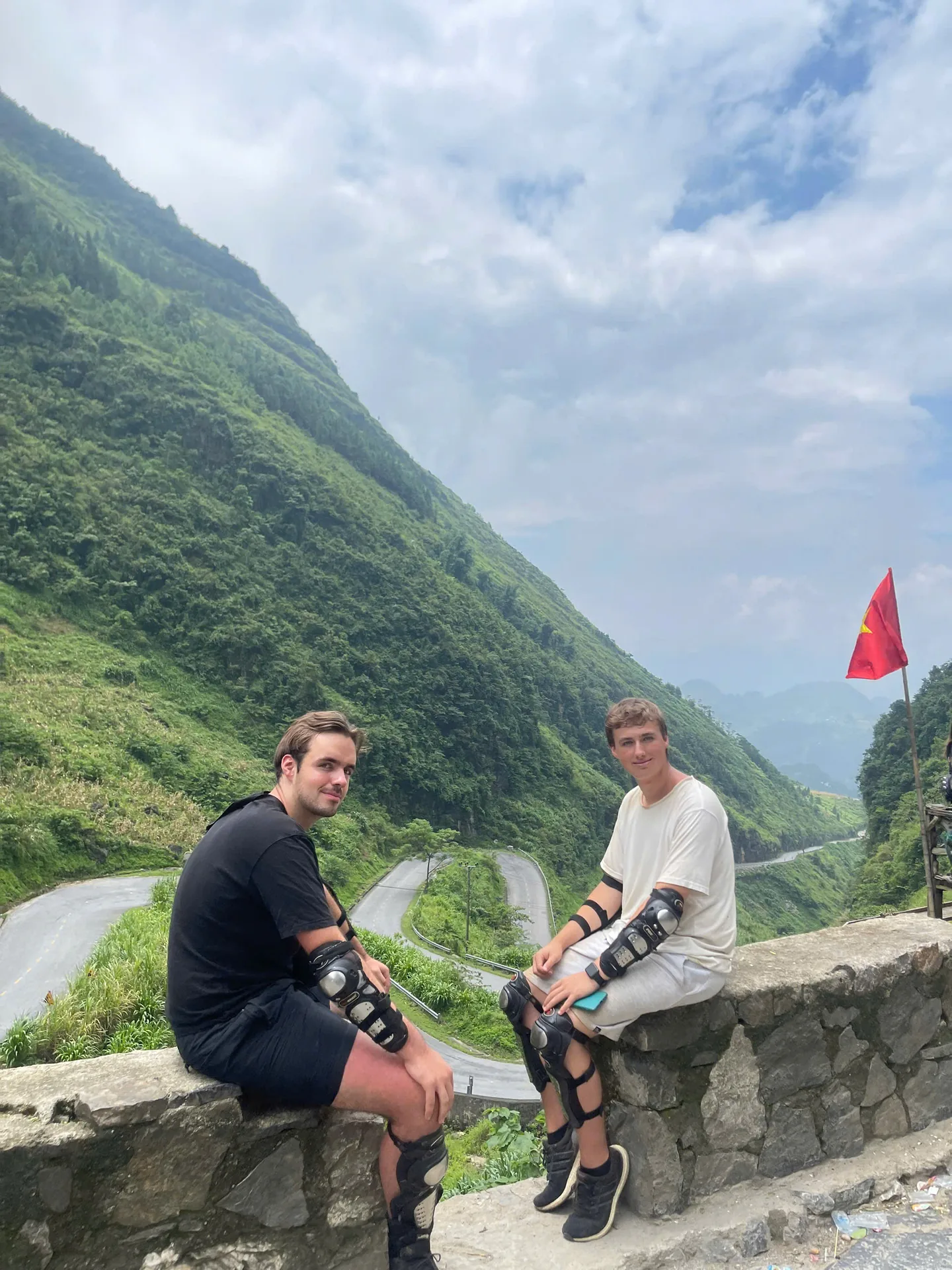 Freedom guests laughing together at a viewpoint over the valleys of the Ha Giang Loop